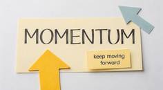 note that says momentum with an upward arrow