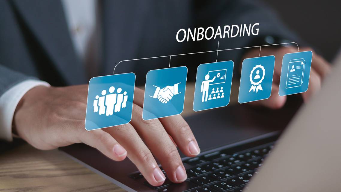 Person typing on laptop with the word Onboarding above