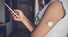 continuous glucose monitor on woman arm